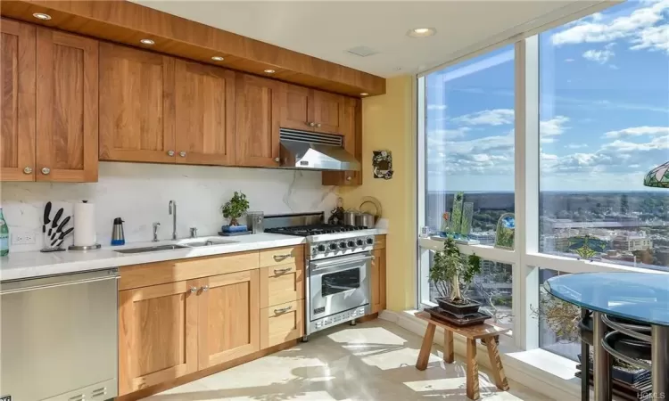 Kitchen featuring decorative backsplash, stainless steel appliances, and sink