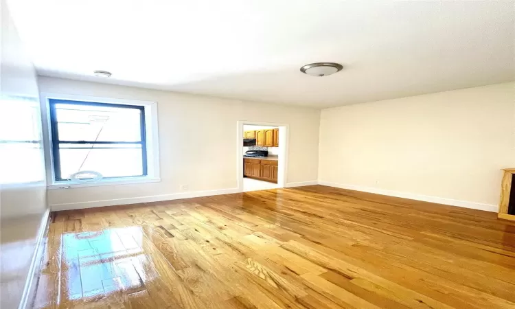 Empty room with light hardwood / wood-style floors