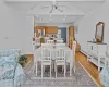 Dining area with ceiling fan, vaulted ceiling, and light hardwood / wood-style flooring