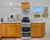 Kitchen with stainless steel range, ceiling fan, and sink