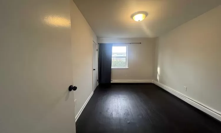 Spare room with dark hardwood / wood-style floors