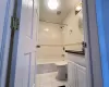 Full bathroom with tile patterned flooring, vanity, tiled shower / bath combo, and toilet