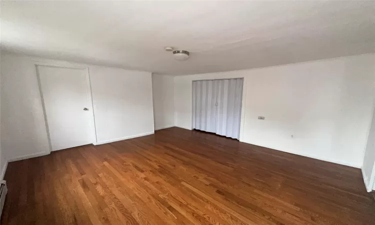 Spare room with dark hardwood / wood-style floors