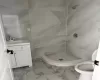 Bathroom with vanity, toilet, and walk in shower