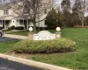 Community / neighborhood sign featuring a yard