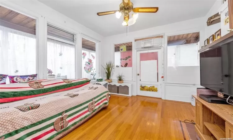 Bedroom featuring ceiling fan and hardwood / wood-style floors