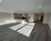 Unfurnished living room featuring dark hardwood / wood-style flooring, sink, and electric panel