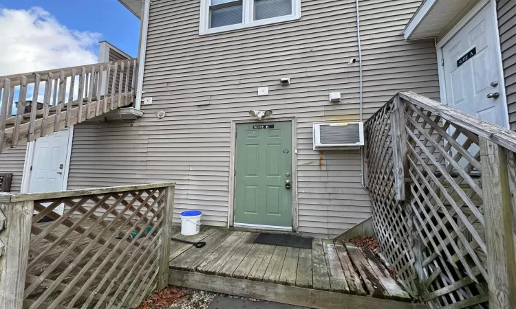 Property entrance featuring a wall unit AC