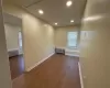 Unfurnished room featuring hardwood / wood-style floors and radiator