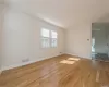 Spare room with light wood-type flooring, plenty of natural light, and crown molding