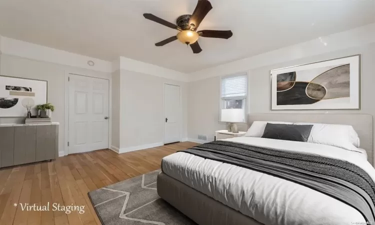 Bedroom with light hardwood / wood-style flooring and ceiling fan