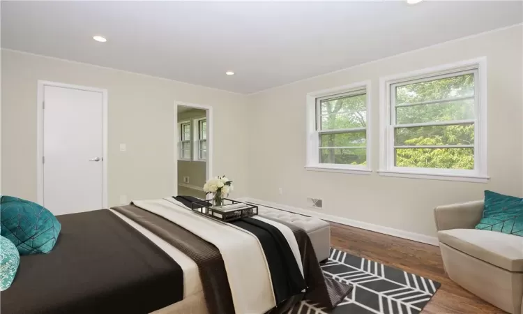 Bedroom with door to walkin closet, ensuite bath renovated in 2019, virtually staged