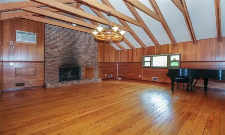 Den with brick fireplace, vaulted beamed cieling, peg and dart hardwood floors, Steinway baby grand