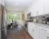 Kitchen with door to laundry room and back yard, virtually staged