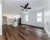 Kitchen with a center island, baseboard heating, stainless steel appliances, and white cabinetry