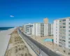 View of building exterior featuring a water view and a beach view