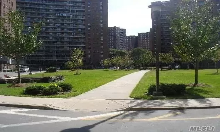 View of home's community with a lawn