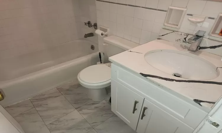 Full bathroom with vanity, tub / shower combination, and toilet