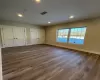 Unfurnished bedroom with two closets and dark wood-type flooring