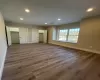 Unfurnished living room with electric panel, hardwood / wood-style flooring, and sink