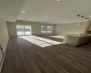 Unfurnished living room with a wealth of natural light, sink, and dark wood-type flooring