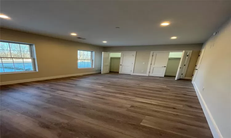 Unfurnished bedroom featuring dark wood-type flooring