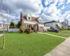 Cape cod-style house with a front yard