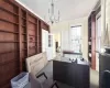 office featuring ornamental molding, dark carpet, and a notable chandelier