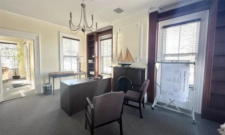 Office featuring carpet floors, crown molding, and a chandelier