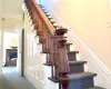 Stairs with a fireplace, carpet floors, and ornamental molding