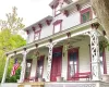 Italianate property featuring covered porch