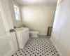 Bathroom featuring tile patterned floors, vanity, and toilet