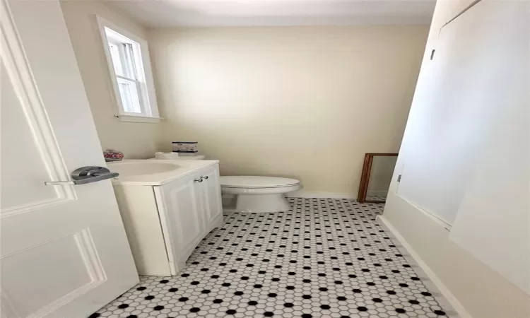 Bathroom featuring tile patterned floors, vanity, and toilet