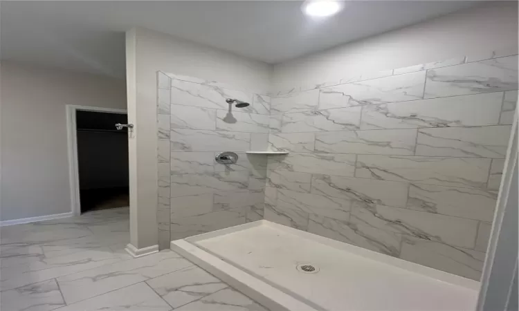 Kitchen with light stone countertops, sink, light hardwood / wood-style floors, decorative backsplash, and appliances with stainless steel finishes