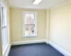 Spare room with carpet and ornamental molding