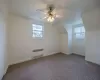 Bonus room with carpet, a wealth of natural light, radiator, and ceiling fan