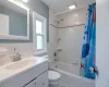 Full bathroom featuring vanity, toilet, a wealth of natural light, and shower / bath combo with shower curtain