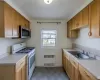 Kitchen featuring radiator, sink, and white gas range oven