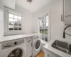 Bathroom with vanity, enclosed tub / shower combo, and tile walls