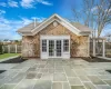 Back of property with a patio area, a yard, a balcony, and french doors