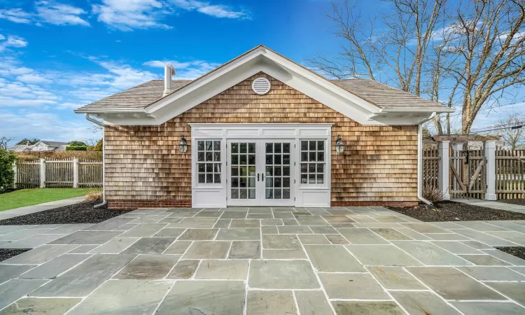 Back of property with a patio area, a yard, a balcony, and french doors