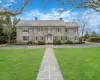 Colonial home featuring a front yard