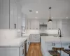 Entryway with ornate columns, crown molding, and light hardwood / wood-style flooring