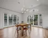 Dining room featuring a notable chandelier, a healthy amount of sunlight, and french doors