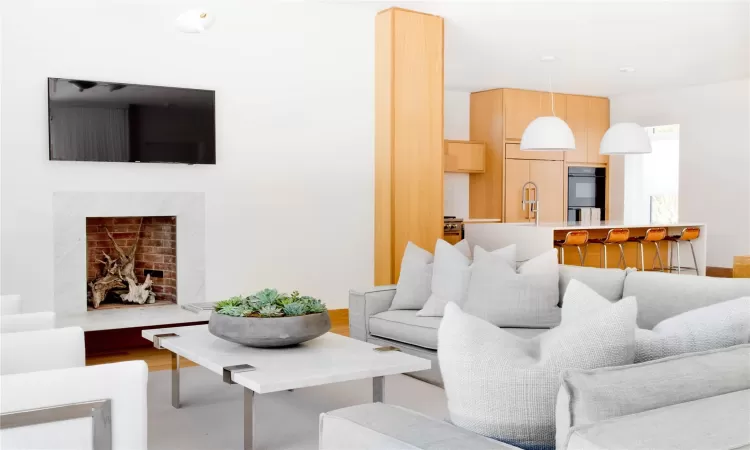 Living room with a fireplace and hardwood / wood-style floors