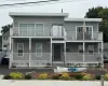 View of front of home featuring covered porch and a balcony