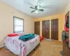 Carpeted bedroom featuring ceiling fan