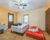 Carpeted bedroom featuring ceiling fan