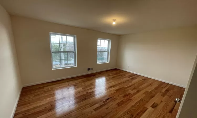 Unfurnished room with hardwood / wood-style floors