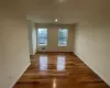 Spare room featuring wood-type flooring